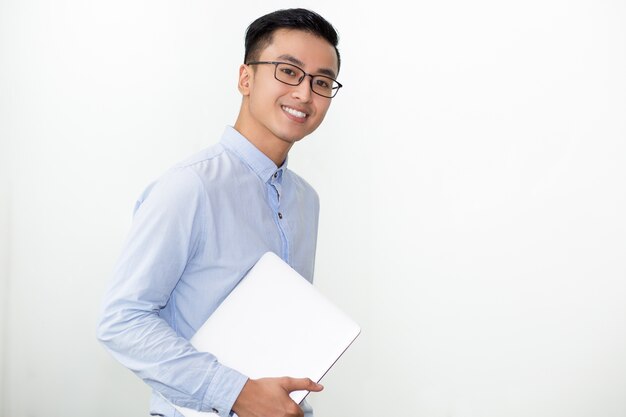 Smiling Student in Glasses Carrying Laptop