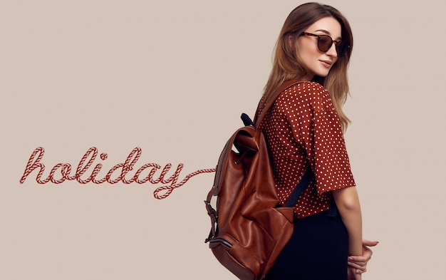 Free photo smiling student hipster woman with backpack going on a vacation