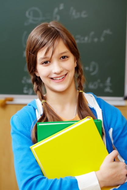 Smiling student with blackboard background