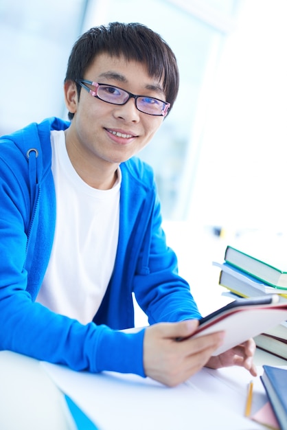 Smiling student with his digital tablet