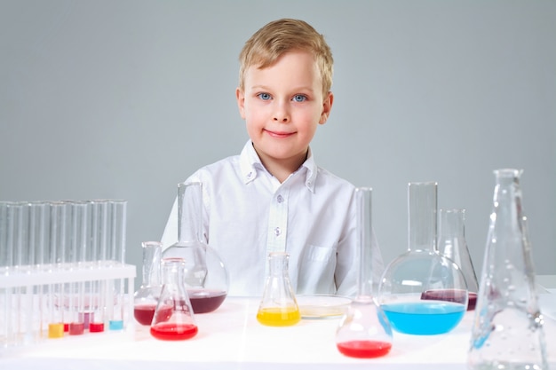 Free photo smiling student with test tubes and flasks