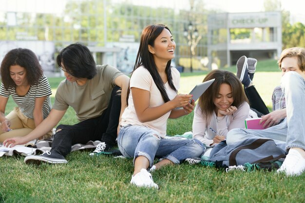 Smiling students studying outdoors