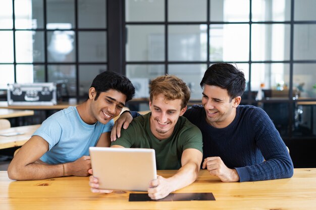 Smiling students watching media content or having video call