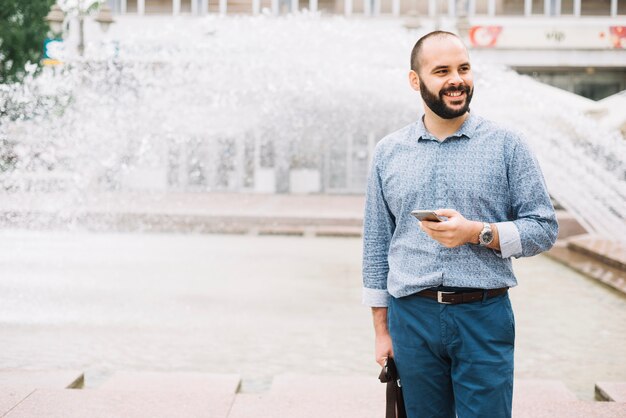 smiling stylish man posing at street
