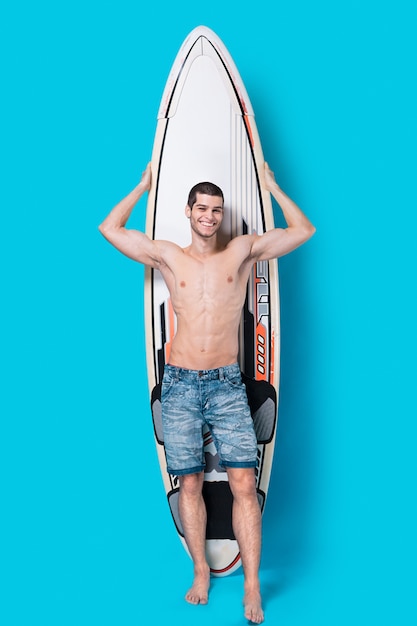 Smiling surfer holding a surfboard