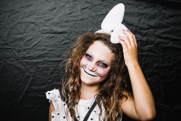Smiling teen girl in hare paint