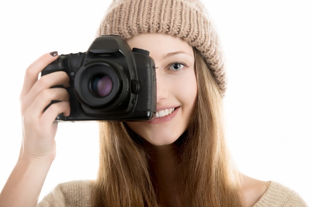 Smiling teenage girl take a photograph