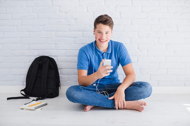 Free photo smiling teenager listening to music