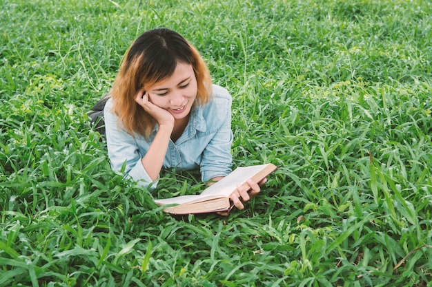 Smiling teenager reading a novel