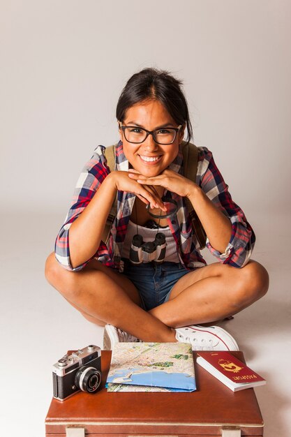 Smiling tourist woman sitting