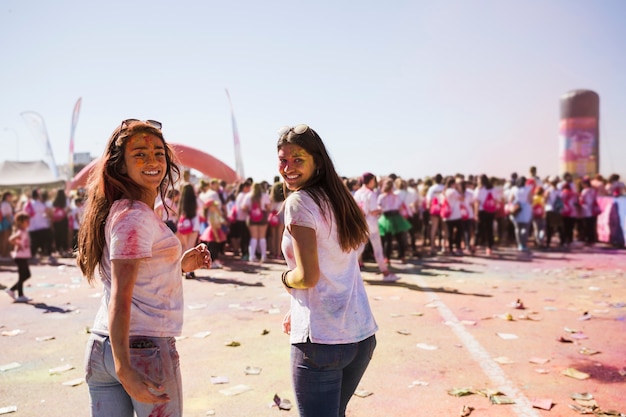 Smiling two young women enjoying the holi festival