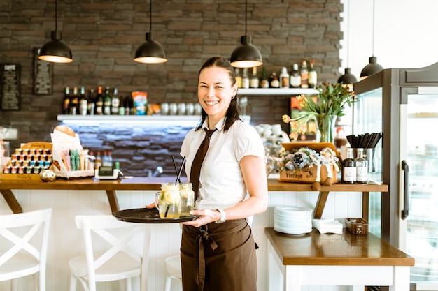 Smiling waitress with cocktail