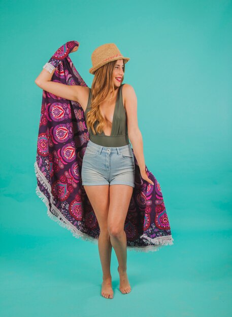 Smiling woman in beachwear with towel