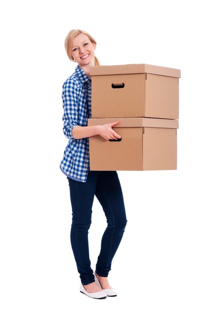 Smiling woman carrying two boxes