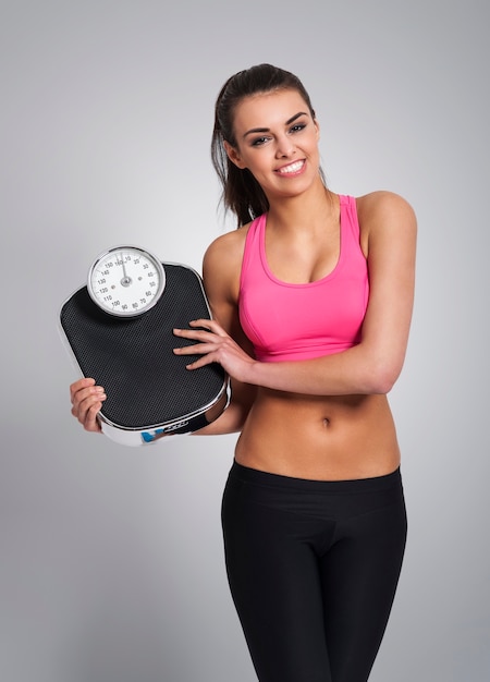 Smiling woman controlling her weight