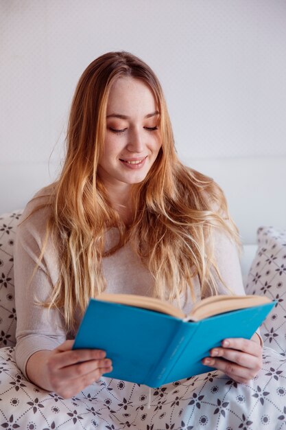 Smiling woman enjoying reading