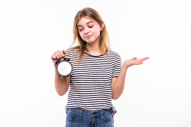 Smiling woman in eyeglasses holding alarm clock