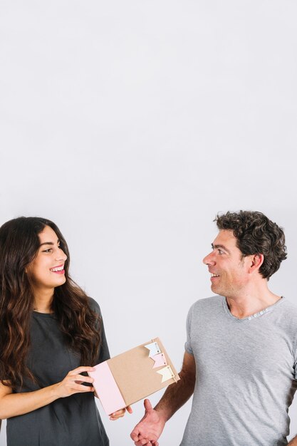 Smiling woman giving gift to father