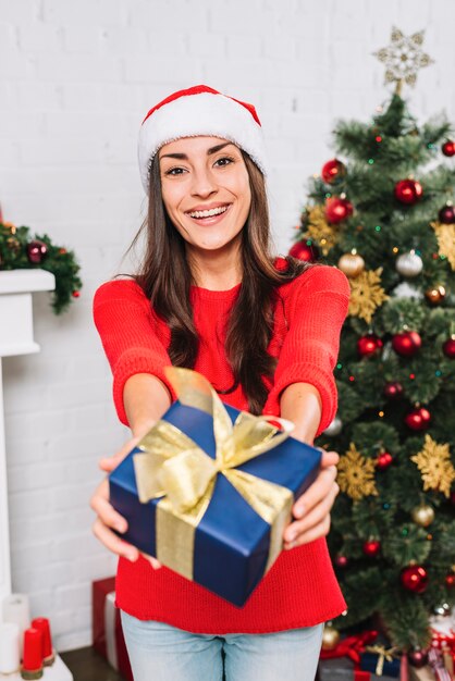 Smiling woman giving present box