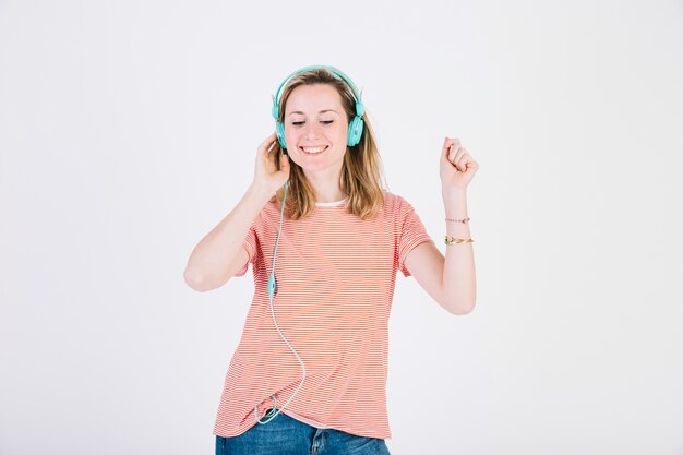 Smiling woman in headphones dancing