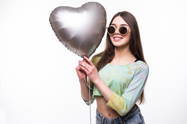 Smiling woman holding heart balloon.
