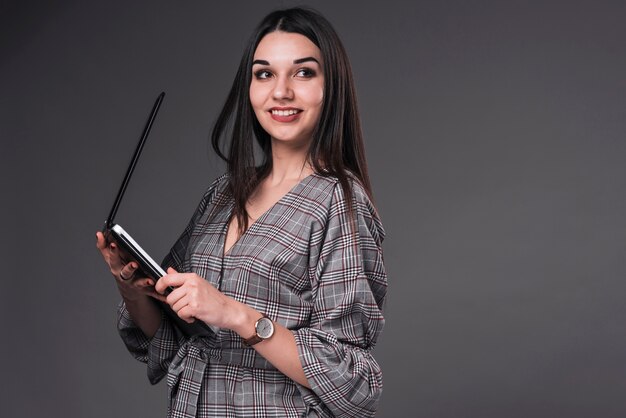 Smiling woman holding laptop