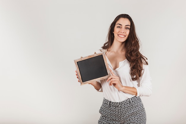 Smiling woman holding a slate