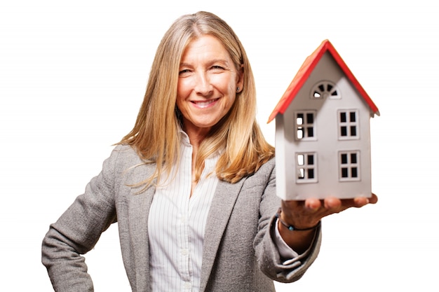 Smiling woman holding a toy house