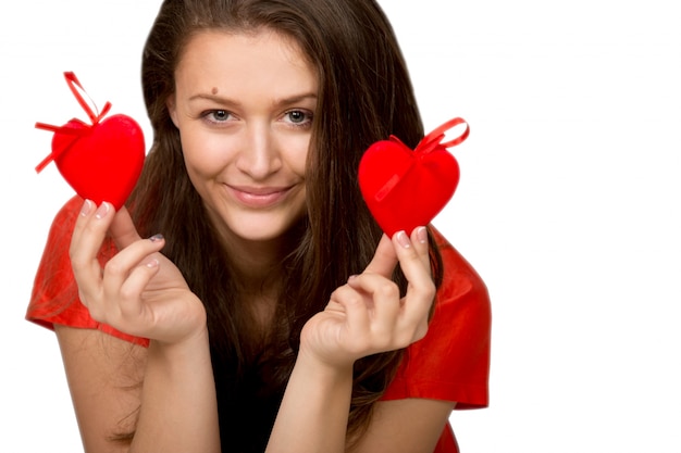 Free photo smiling woman holding two red hearts