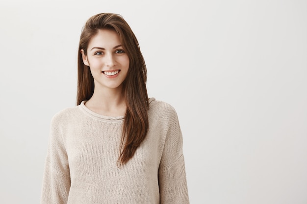 smiling woman looking at front delighted