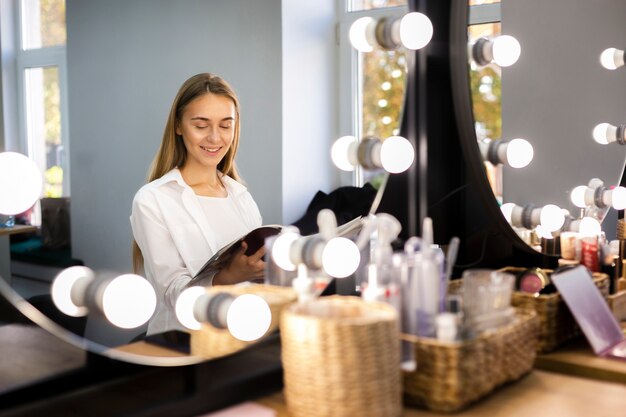 Smiling woman looking through magazine