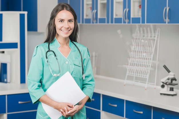 Smiling woman medic with papers