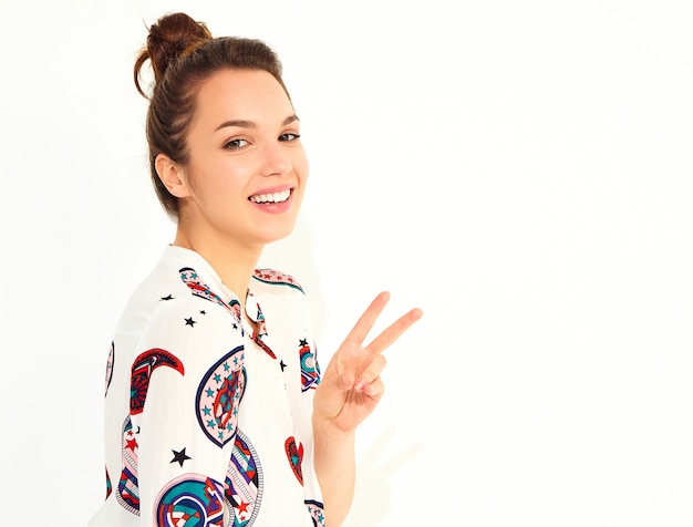Smiling woman model in casual summer clothes, showing peace sign