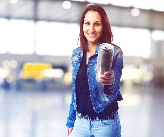 Smiling woman offering a can