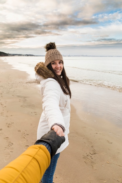 Smiling woman offering to follow her