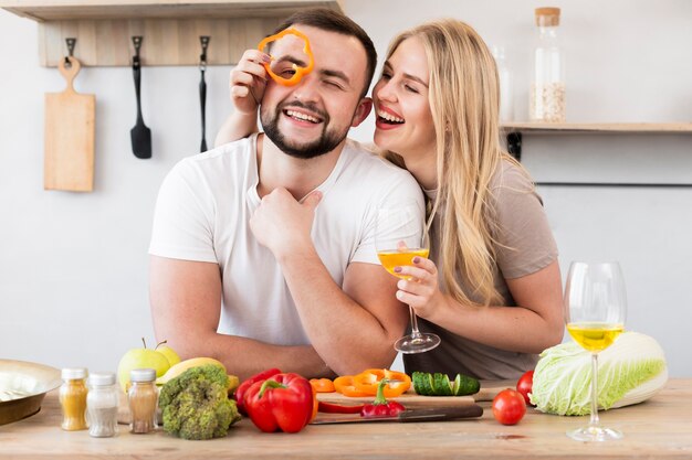 Smiling woman playing with bell pepper