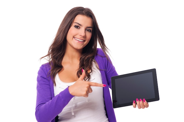 Smiling woman pointing at screen of digital tablet