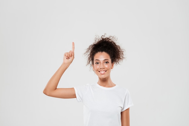 Smiling woman pointing up