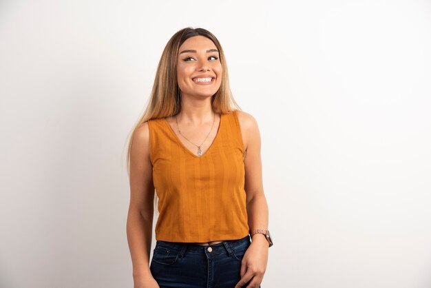 Smiling woman posing on white background.