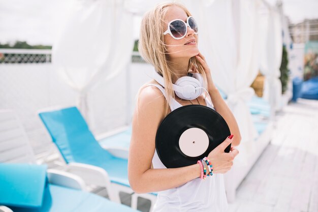 Smiling woman posing with vinyl record