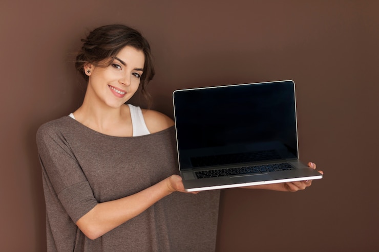 Free Photo smiling woman presenting contemporary laptop