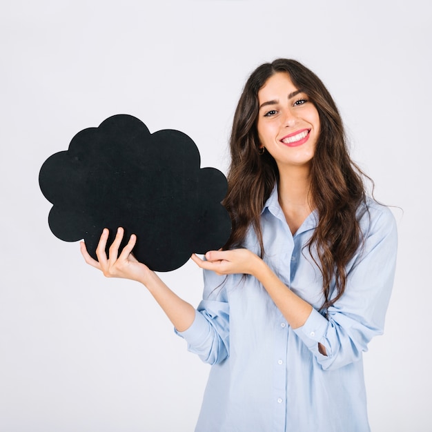 Smiling woman presenting speech bubble slate