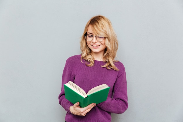 Smiling woman reading book