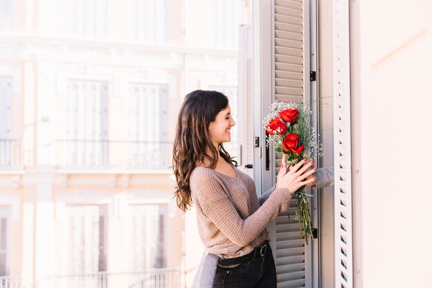 Smiling woman receiving bouquet