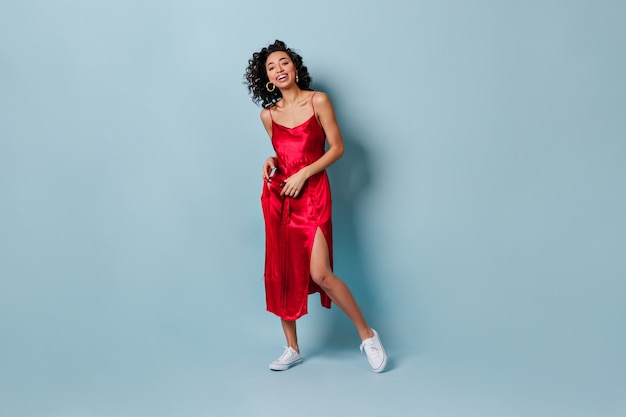 Smiling woman in red dress expressing happiness