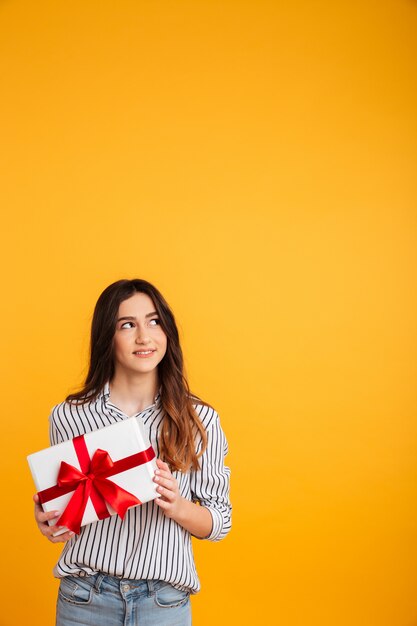 Smiling woman in shirt holding gift box