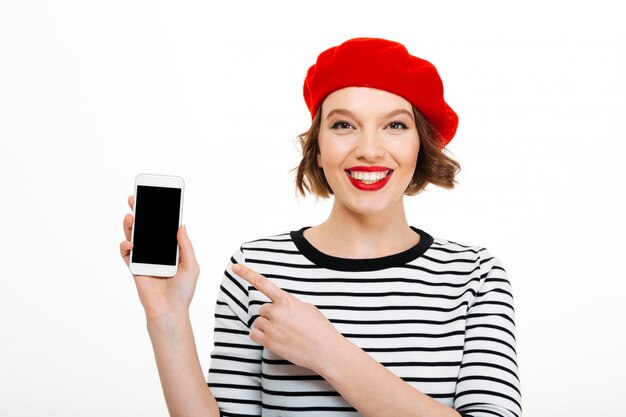 Smiling woman showing display of mobile phone