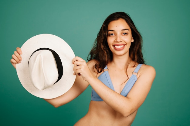 Smiling woman showing hat