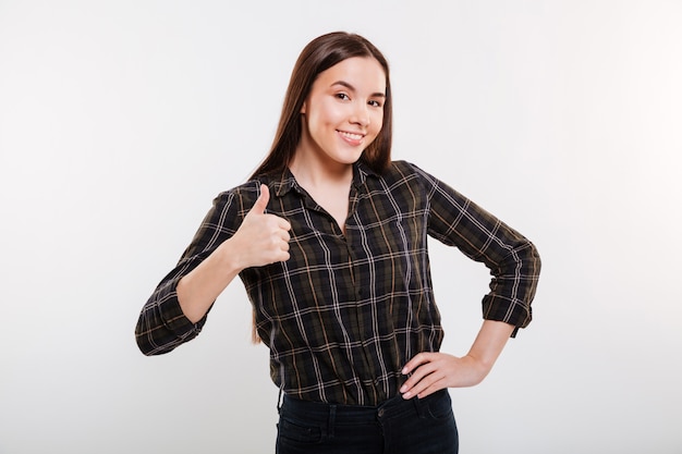 Smiling Woman showing thumb up with arm at hip