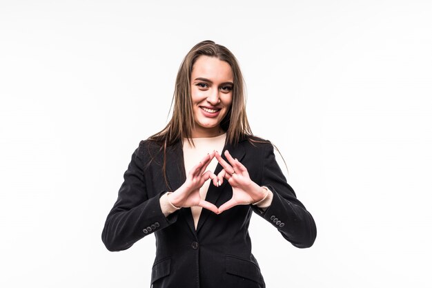 Smiling woman shows heart sign isolated over white